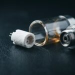 Disassembled vape cartridge showing the ceramic heating core