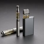A 510 vape cartridge on a pen battery next to a pod-style vape device